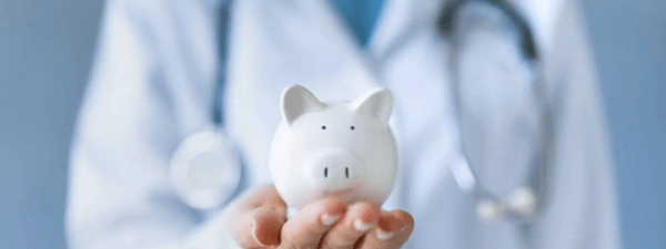 Medical Professional Holding a Piggy Bank Medical Professional Holding a Piggy Bank