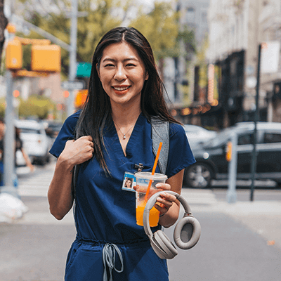 Nurse Walking to Work with Coffee in hand