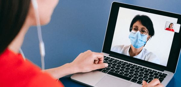 Woman using laptop talking to a doctor